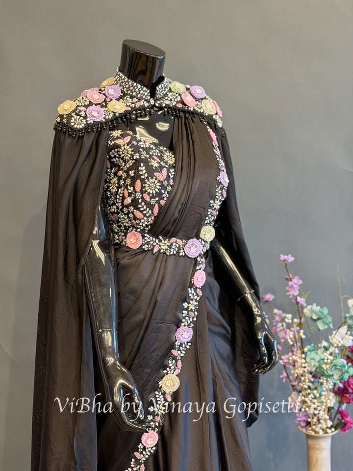 Black pre draped saree and blouse with a cape