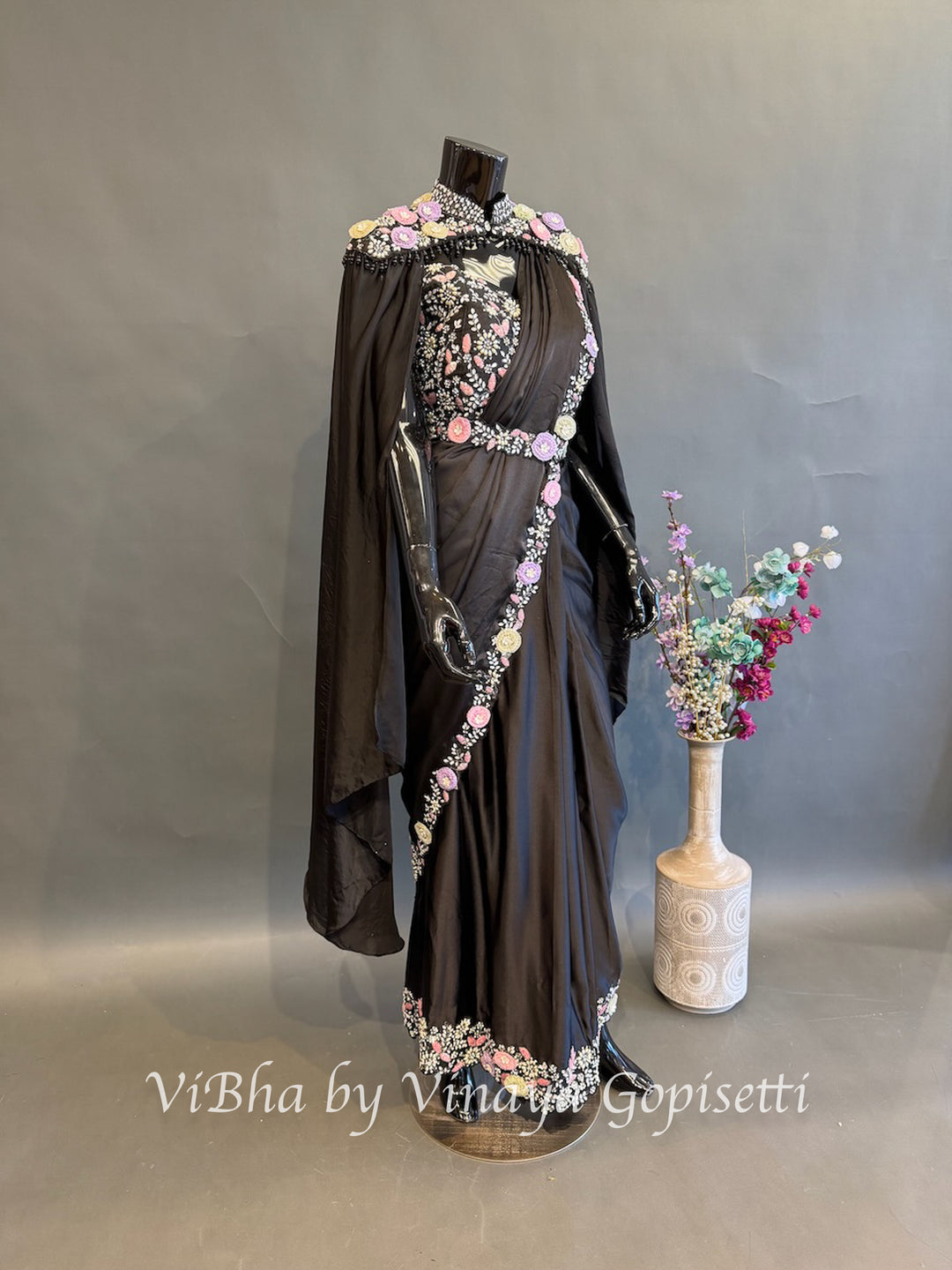 Black pre draped saree and blouse with a cape