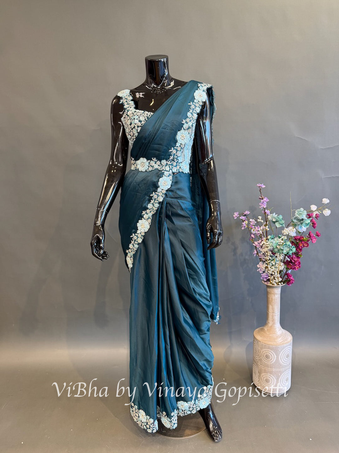 Peacock Blue pre draped saree with a sleeveless blouse