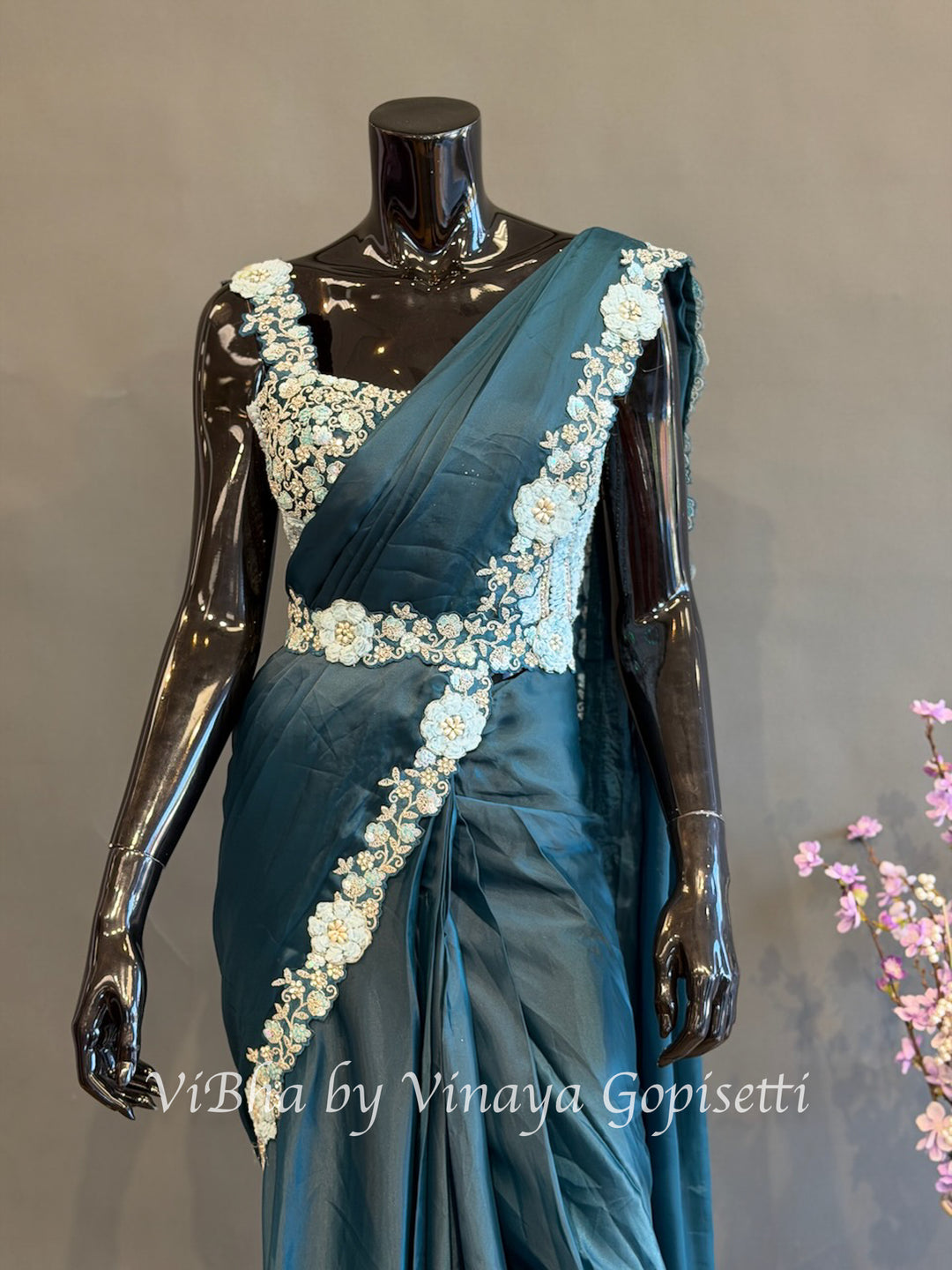 Peacock Blue pre draped saree with a sleeveless blouse