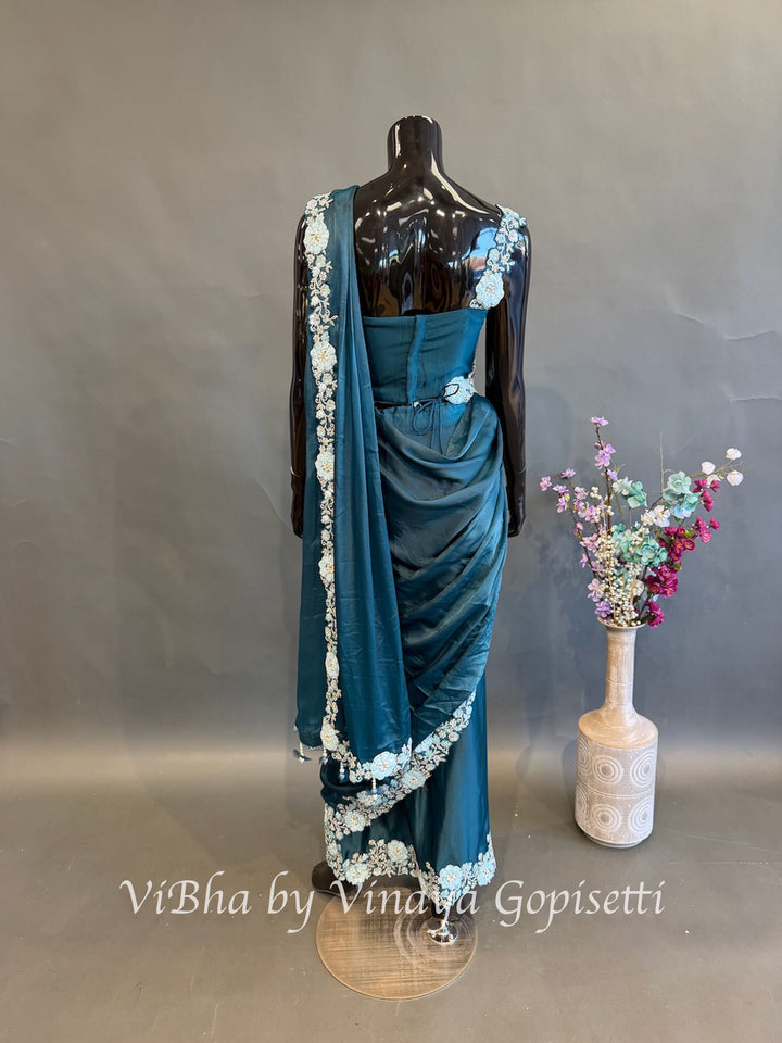 Peacock Blue pre draped saree with a sleeveless blouse