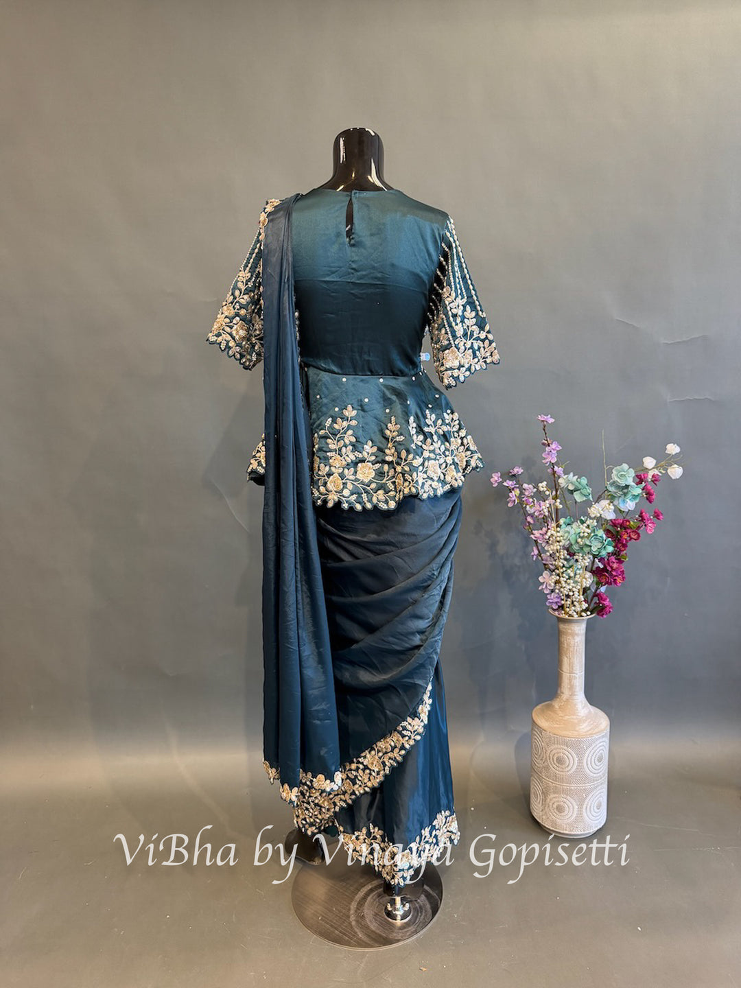 Peacock blue pre draped saree with a peplum blouse