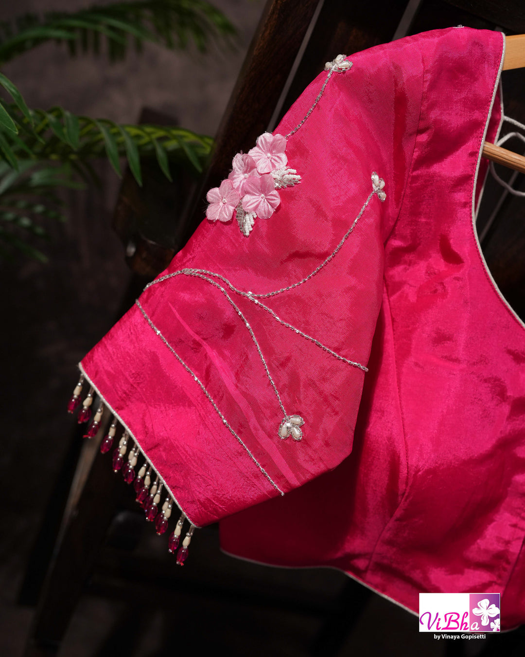 Pink Shimmer Designer Saree with Floral Detailing and Fuchsia Blouse Styling