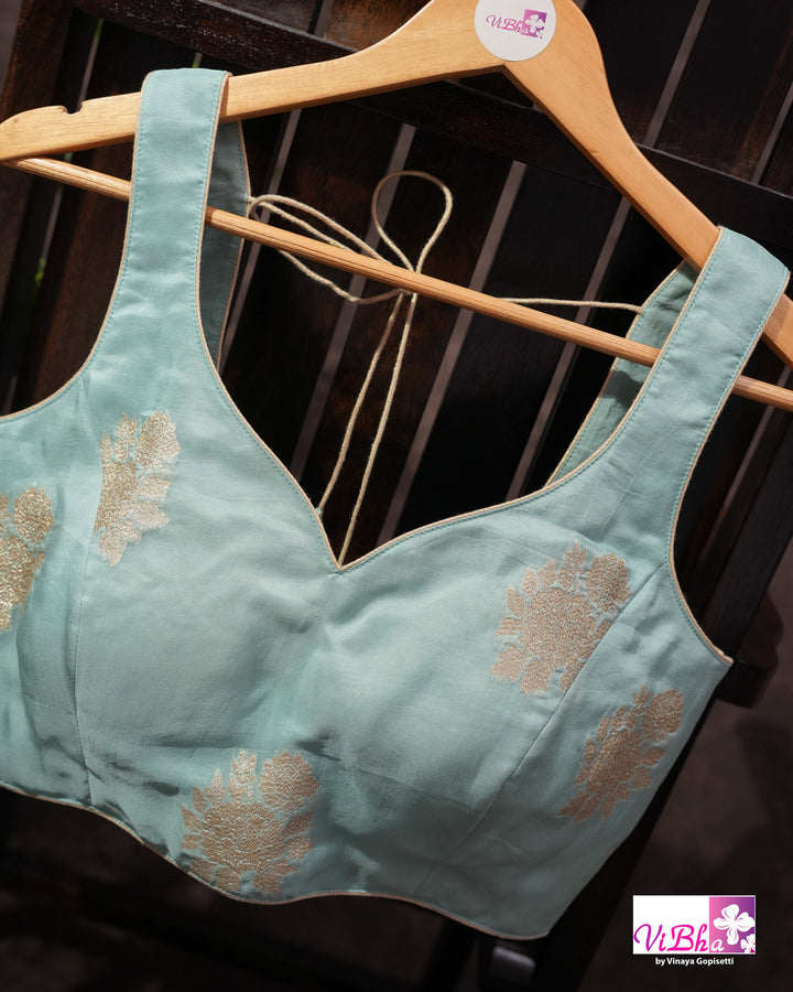 Teal Designer Saree with Floral Motifs and Embroidered Vine Border