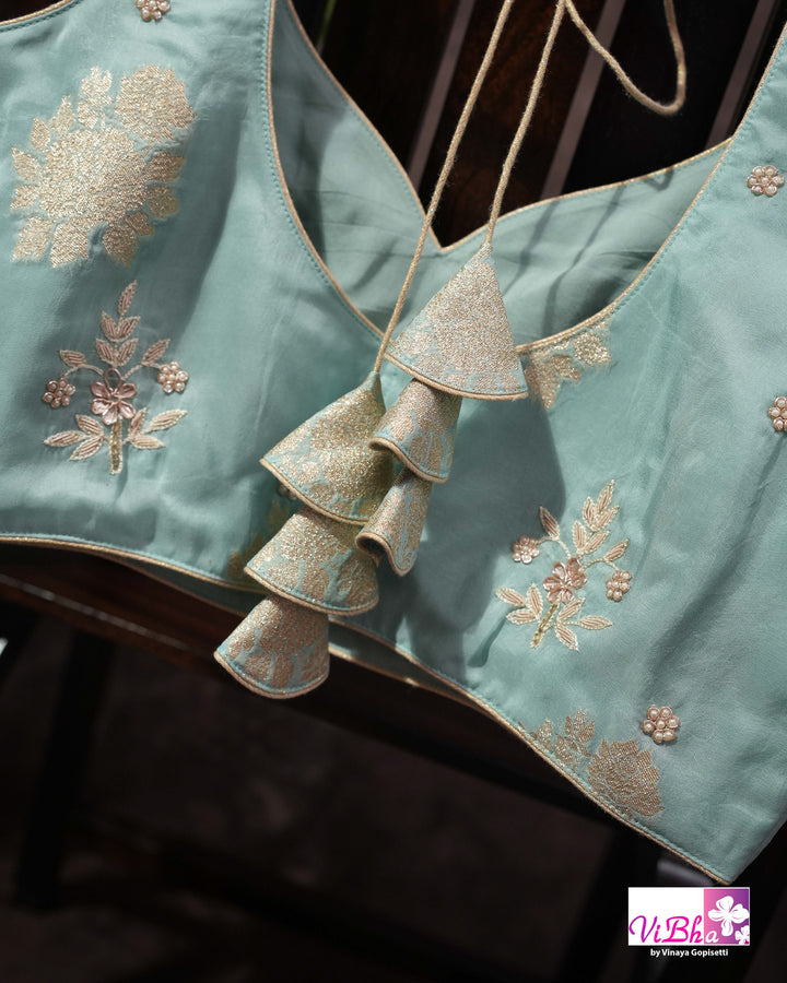 Teal Designer Saree with Floral Motifs and Embroidered Vine Border