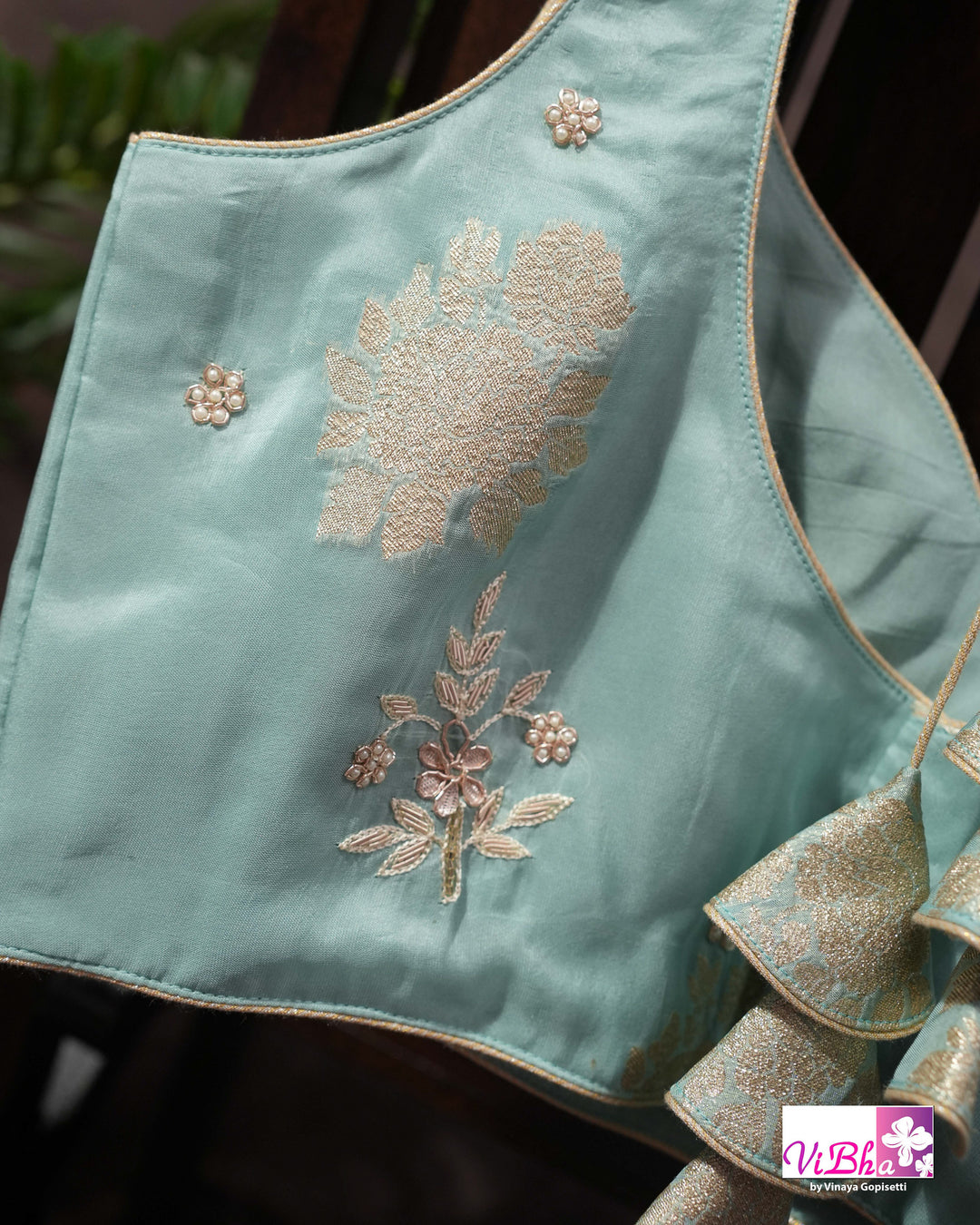 Teal Designer Saree with Floral Motifs and Embroidered Vine Border