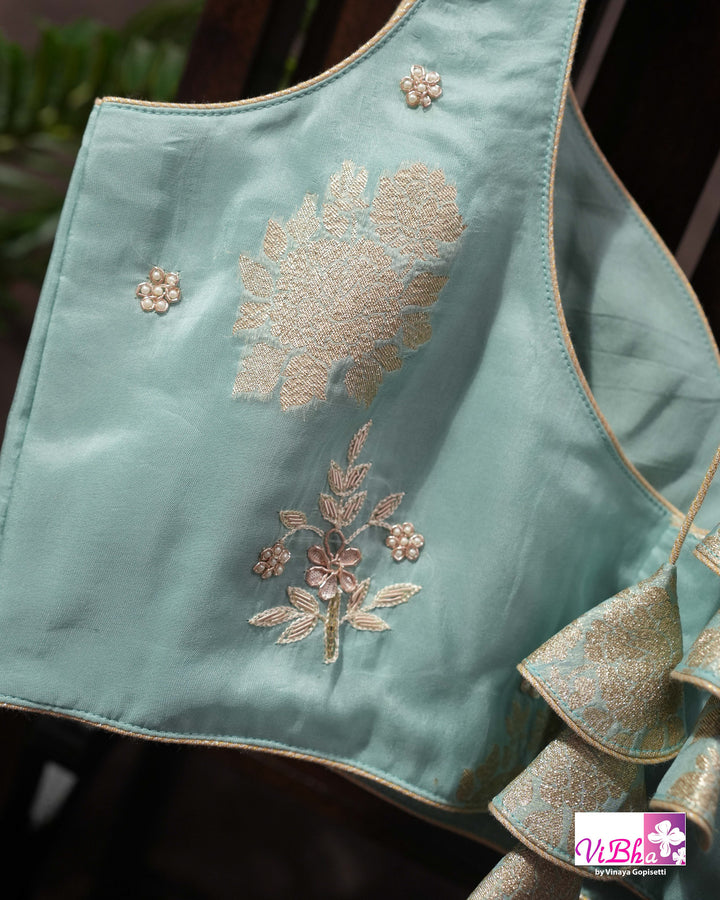 Teal Designer Saree with Floral Motifs and Embroidered Vine Border