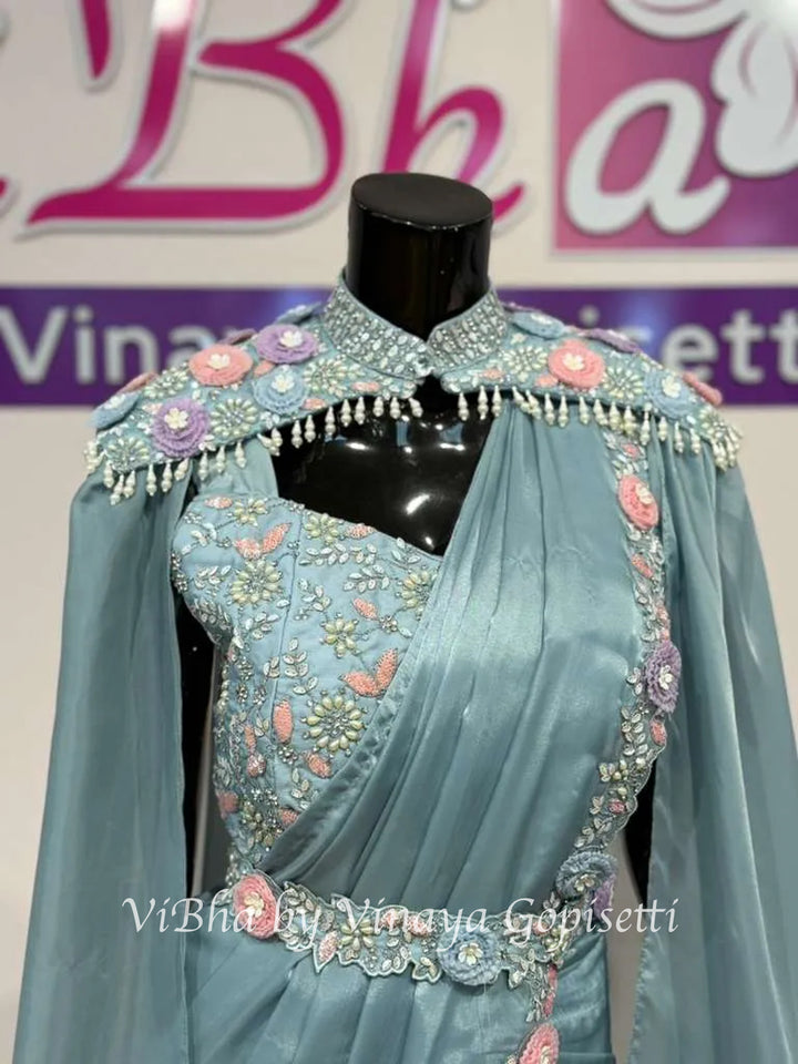 Powder blue pre draped saree and blouse with a cape