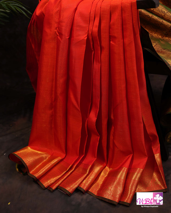 Vermilion Orange Kanchi Silk Saree with Gold Zari Weaving and Green Embroidered Blouse
