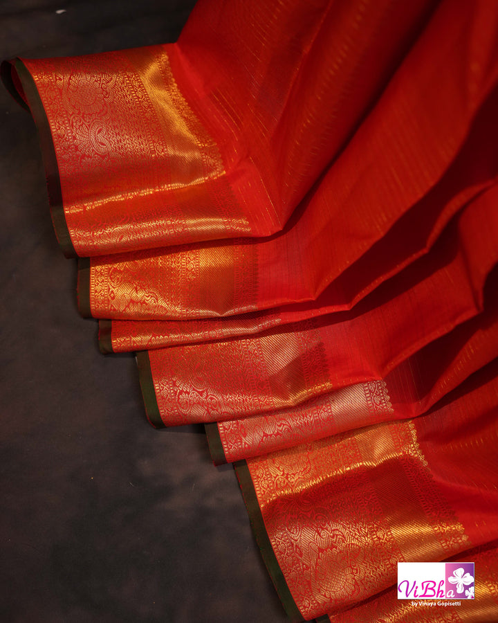 Vermilion Orange Kanchi Silk Saree with Gold Zari Weaving and Green Embroidered Blouse