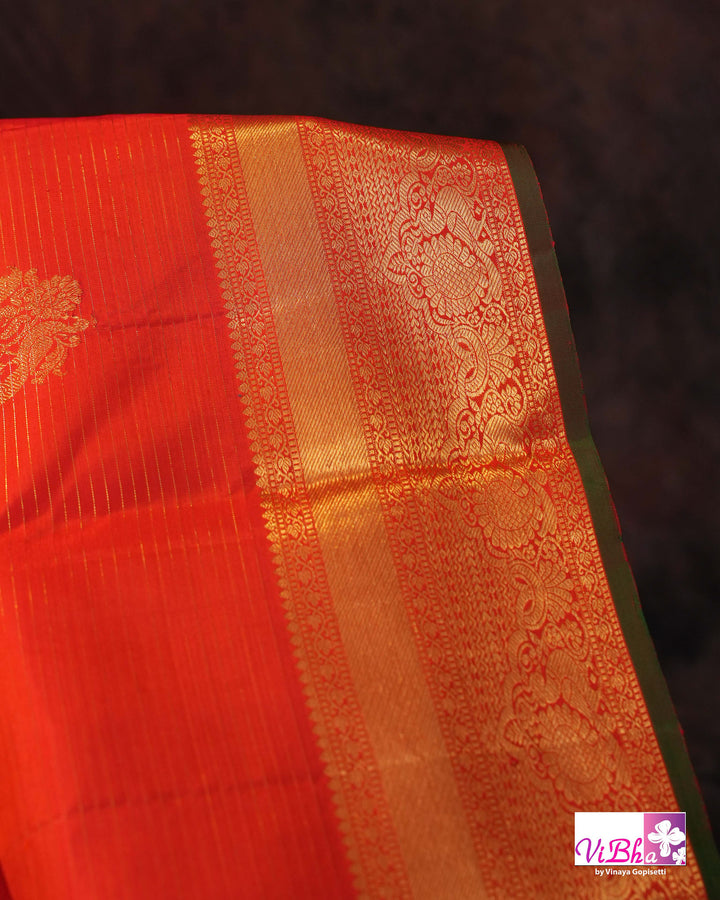 Vermilion Orange Kanchi Silk Saree with Gold Zari Weaving and Green Embroidered Blouse