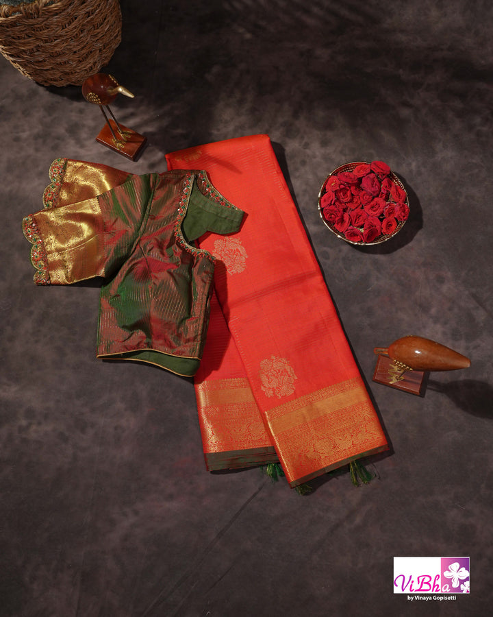 Vermilion Orange Kanchi Silk Saree with Gold Zari Weaving and Green Embroidered Blouse