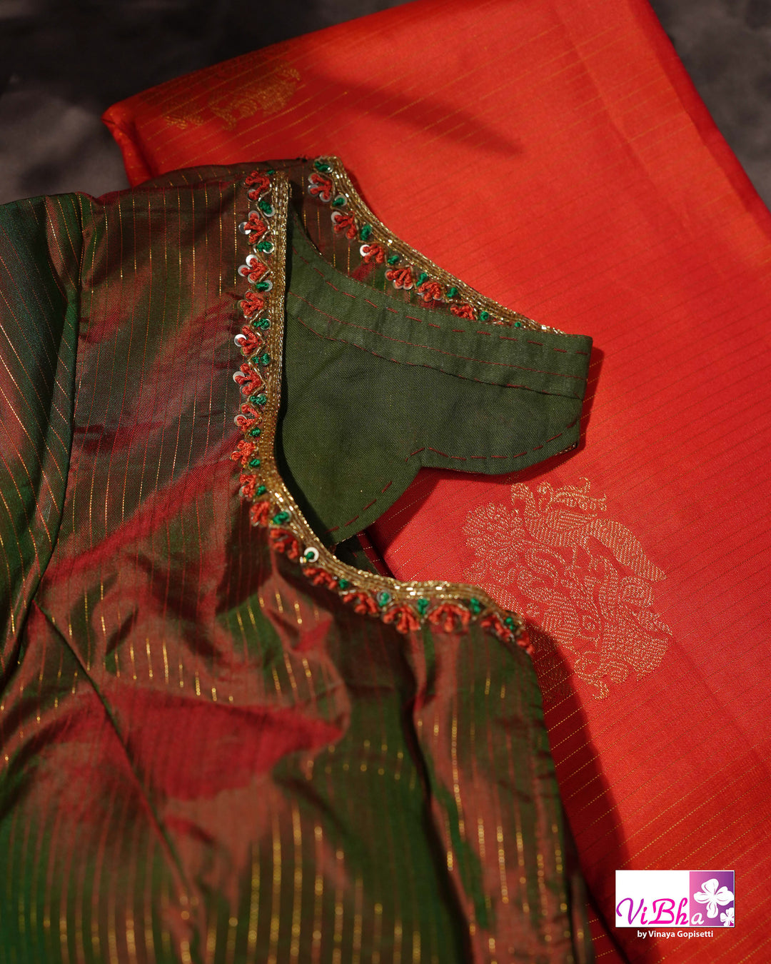 Vermilion Orange Kanchi Silk Saree with Gold Zari Weaving and Green Embroidered Blouse