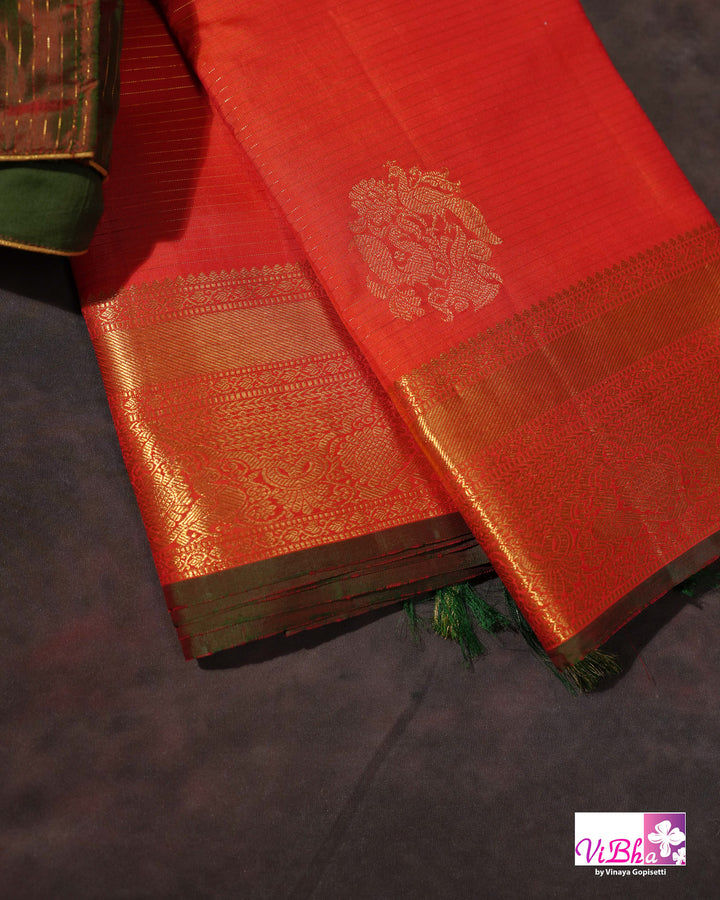 Vermilion Orange Kanchi Silk Saree with Gold Zari Weaving and Green Embroidered Blouse
