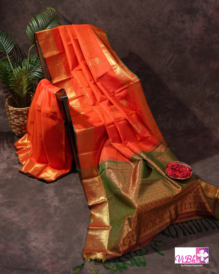 Vermilion Orange Kanchi Silk Saree with Gold Zari Weaving and Green Embroidered Blouse