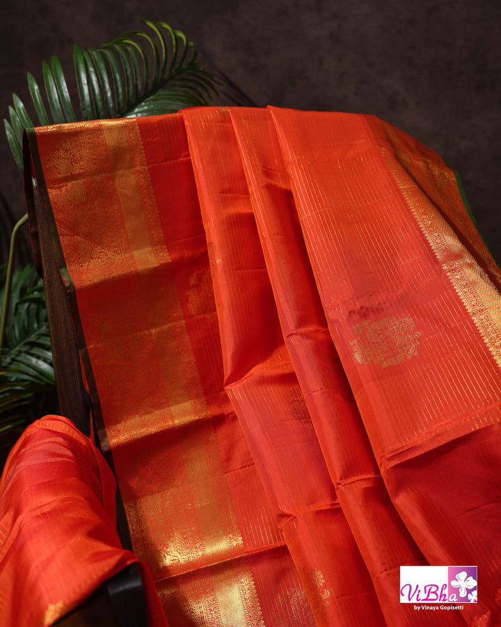 Vermilion Orange Kanchi Silk Saree with Gold Zari Weaving and Green Embroidered Blouse
