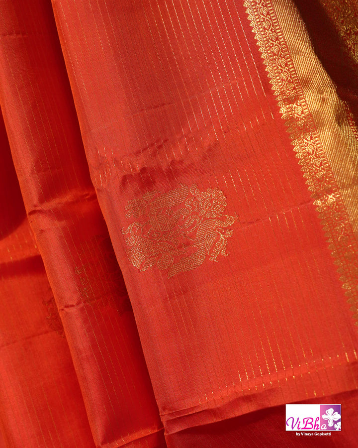 Vermilion Orange Kanchi Silk Saree with Gold Zari Weaving and Green Embroidered Blouse
