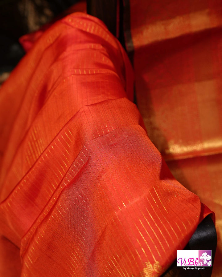 Vermilion Orange Kanchi Silk Saree with Gold Zari Weaving and Green Embroidered Blouse