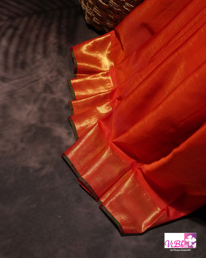 Vermilion Orange Kanchi Silk Saree with Gold Zari Weaving and Green Embroidered Blouse