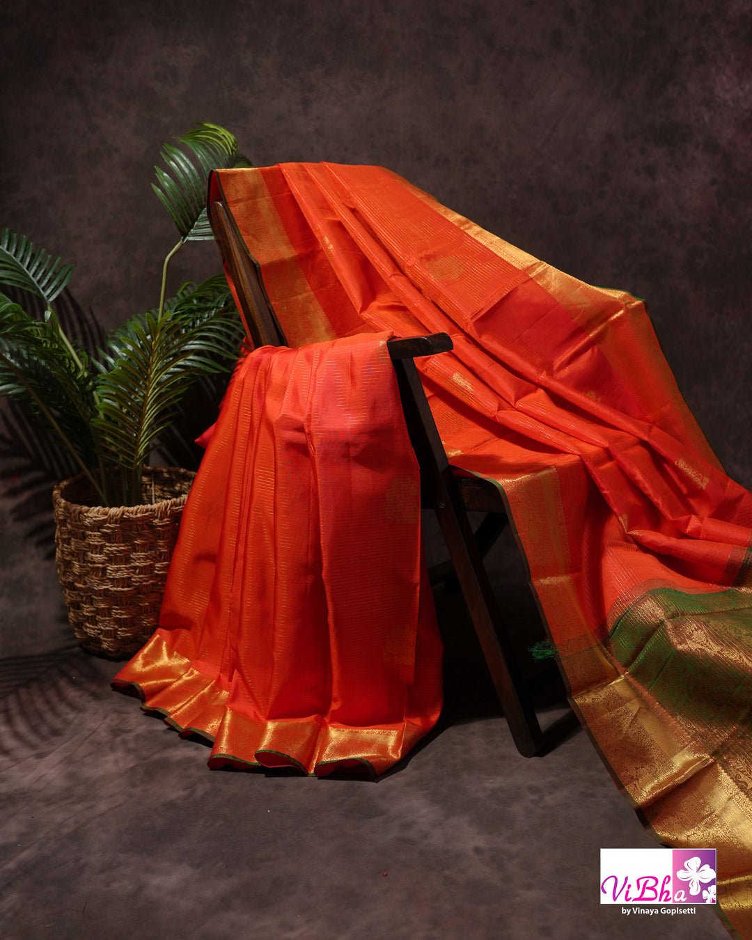 Vermilion Orange Kanchi Silk Saree with Gold Zari Weaving and Green Embroidered Blouse