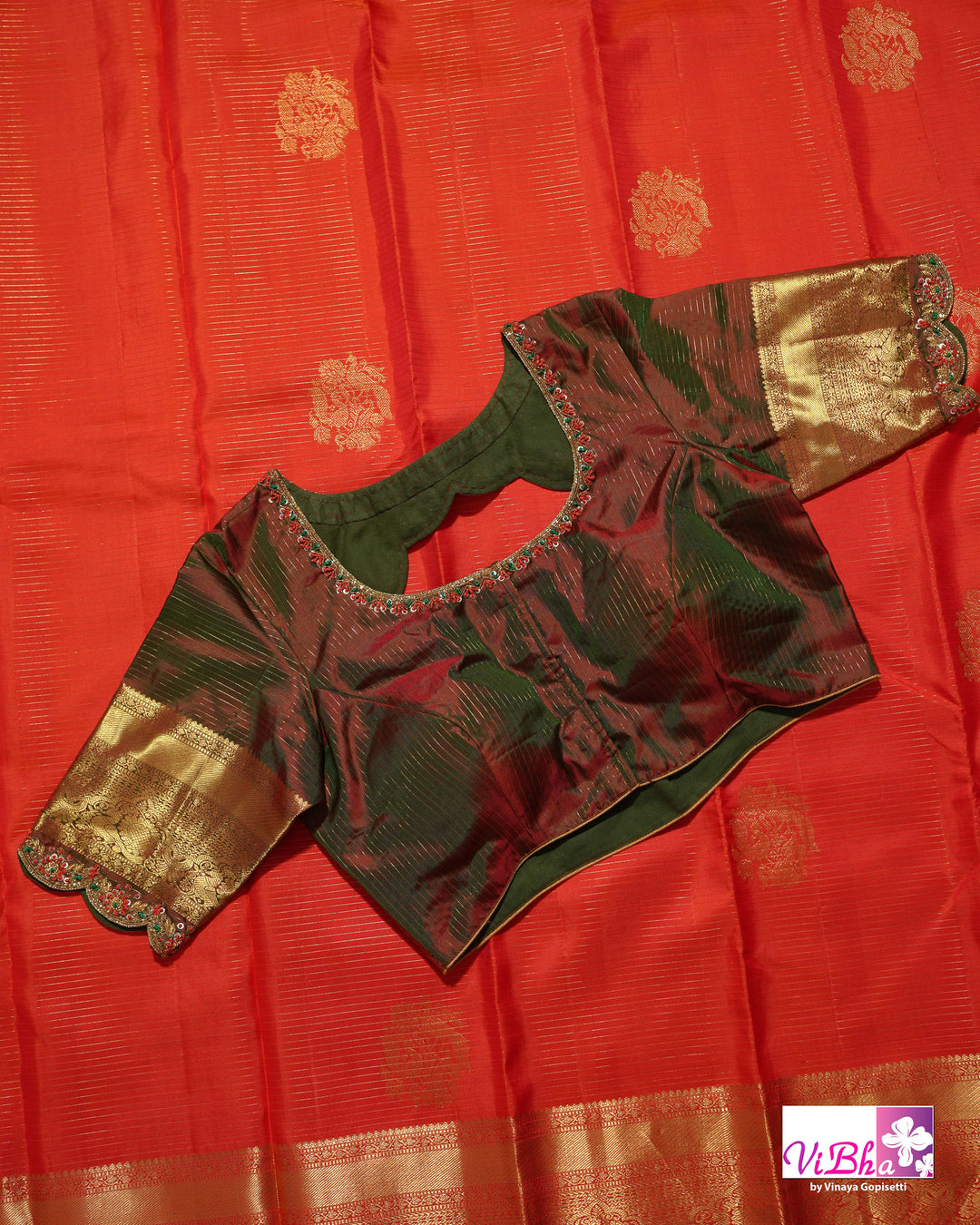 Vermilion Orange Kanchi Silk Saree with Gold Zari Weaving and Green Embroidered Blouse