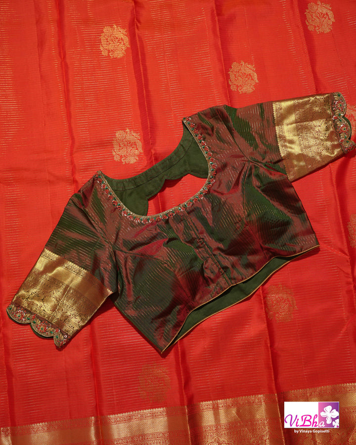 Vermilion Orange Kanchi Silk Saree with Gold Zari Weaving and Green Embroidered Blouse