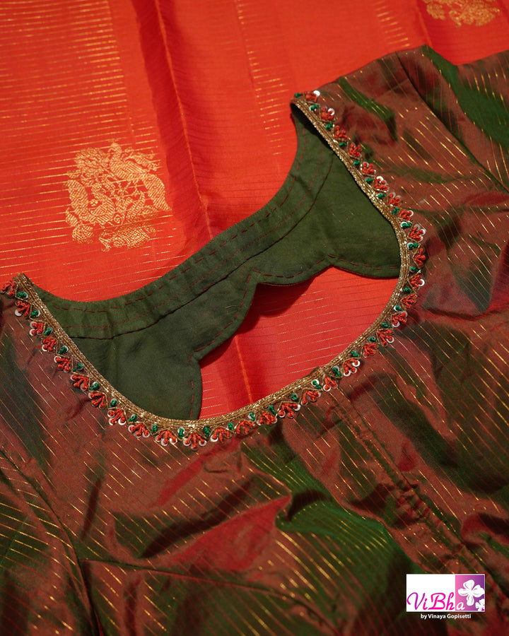 Vermilion Orange Kanchi Silk Saree with Gold Zari Weaving and Green Embroidered Blouse