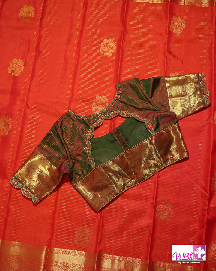 Vermilion Orange Kanchi Silk Saree with Gold Zari Weaving and Green Embroidered Blouse