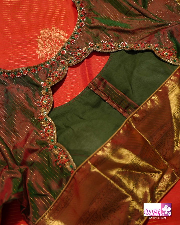 Vermilion Orange Kanchi Silk Saree with Gold Zari Weaving and Green Embroidered Blouse