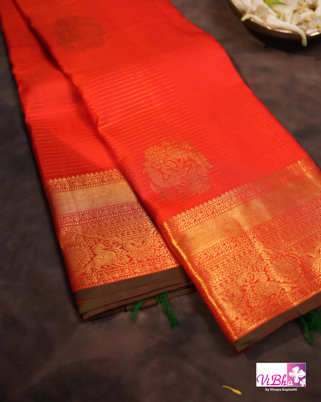Vermilion Orange Kanchi Silk Saree with Gold Zari Weaving and Green Embroidered Blouse