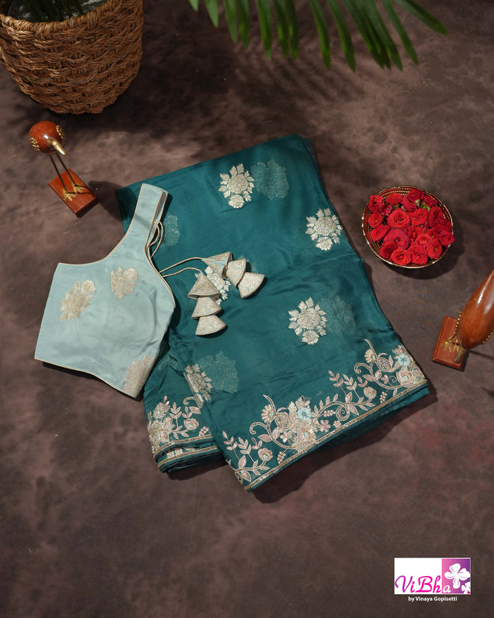 Teal Designer Saree with Floral Motifs and Embroidered Vine Border