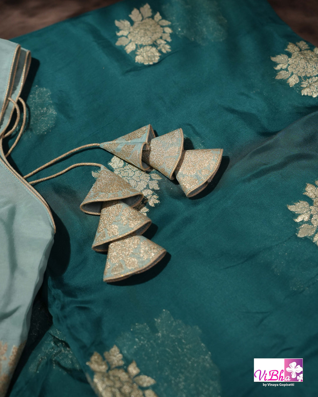 Teal Designer Saree with Floral Motifs and Embroidered Vine Border
