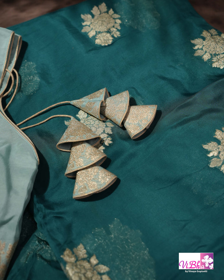 Teal Designer Saree with Floral Motifs and Embroidered Vine Border