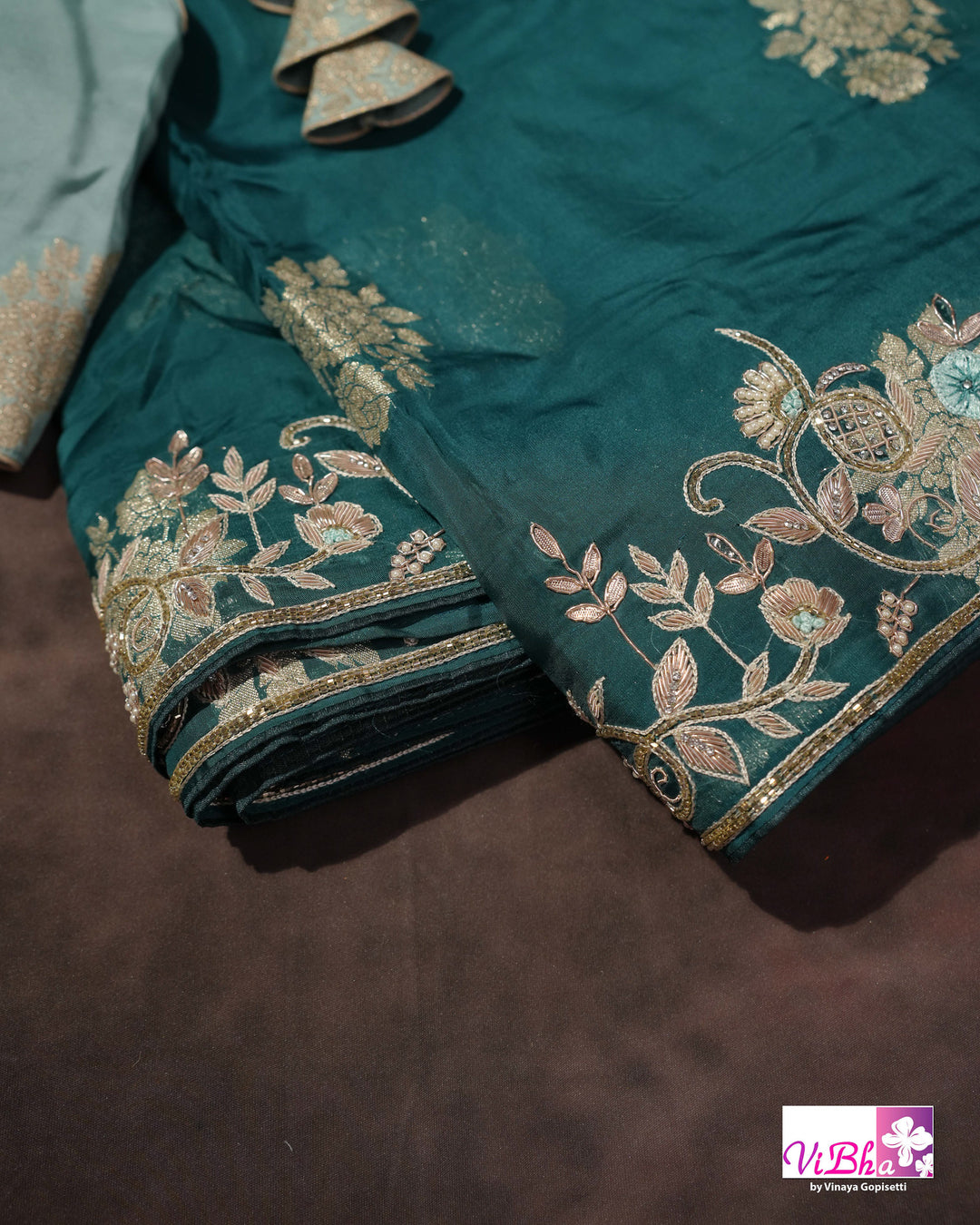 Teal Designer Saree with Floral Motifs and Embroidered Vine Border