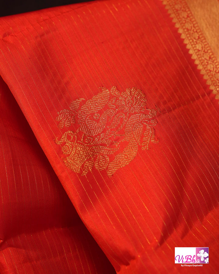 Vermilion Orange Kanchi Silk Saree with Gold Zari Weaving and Green Embroidered Blouse