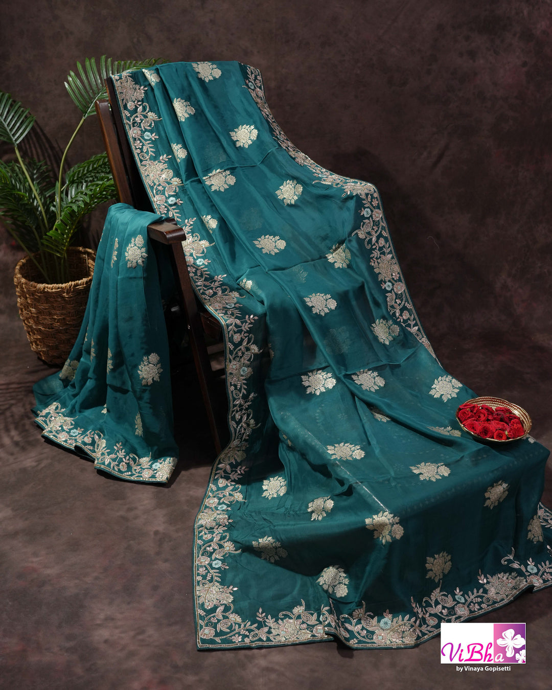 Teal Designer Saree with Floral Motifs and Embroidered Vine Border
