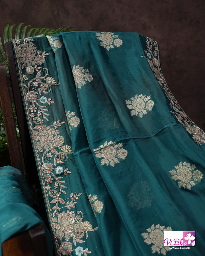 Teal Designer Saree with Floral Motifs and Embroidered Vine Border