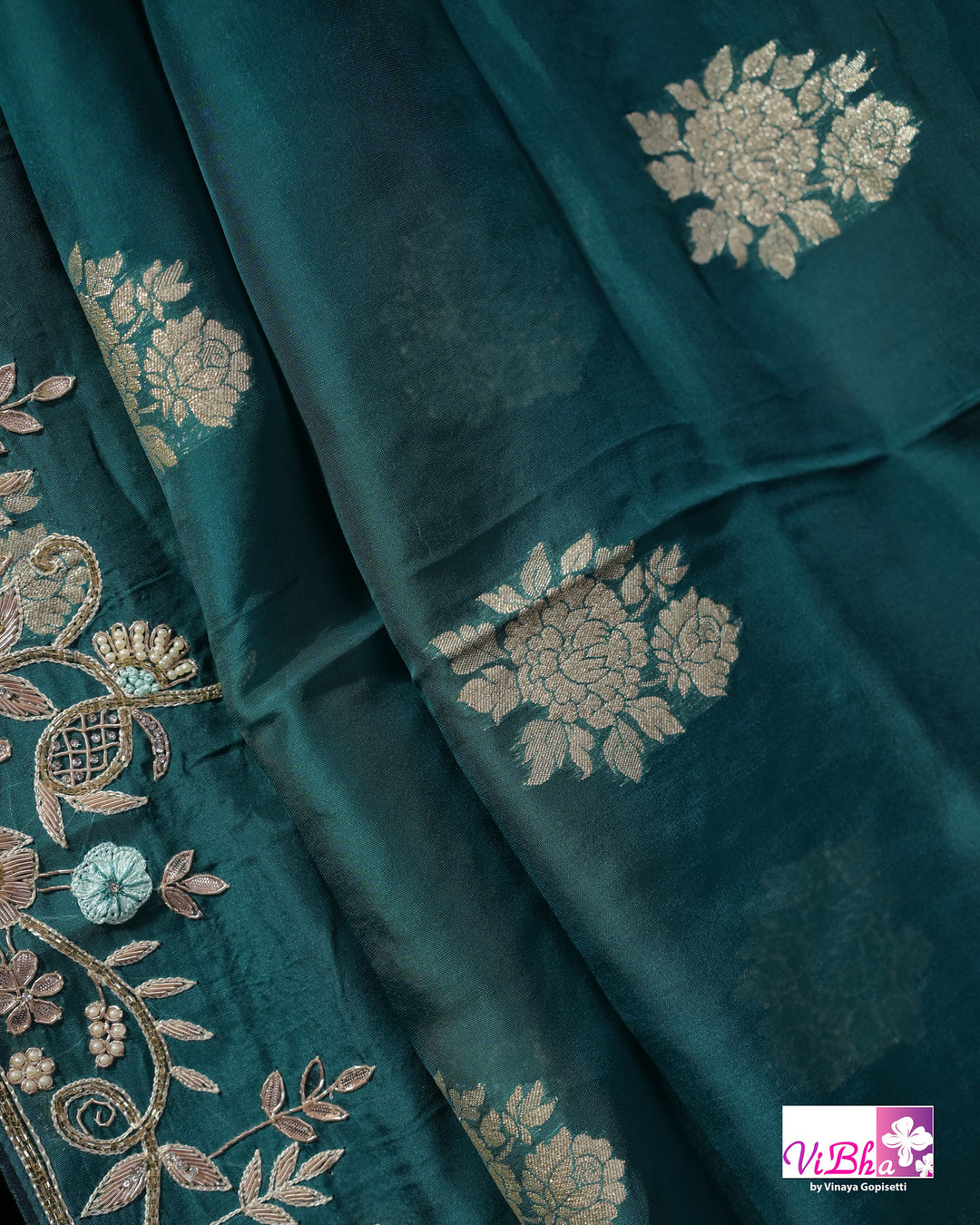 Teal Designer Saree with Floral Motifs and Embroidered Vine Border
