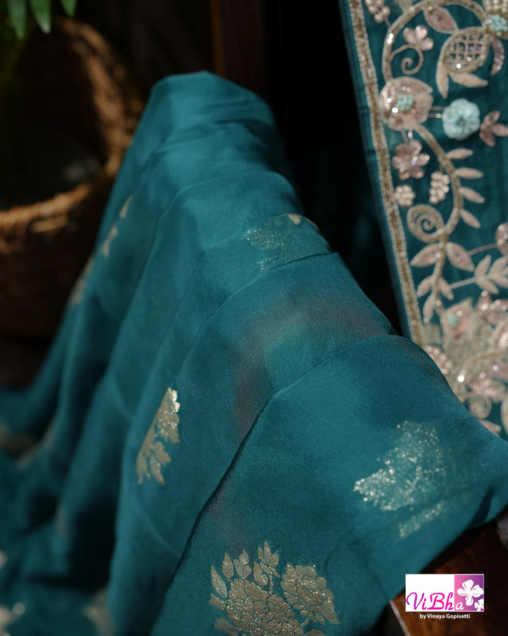 Teal Designer Saree with Floral Motifs and Embroidered Vine Border