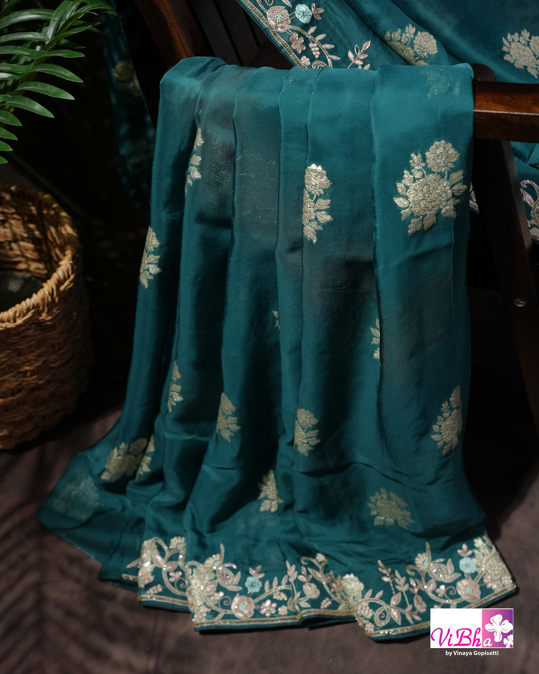 Teal Designer Saree with Floral Motifs and Embroidered Vine Border