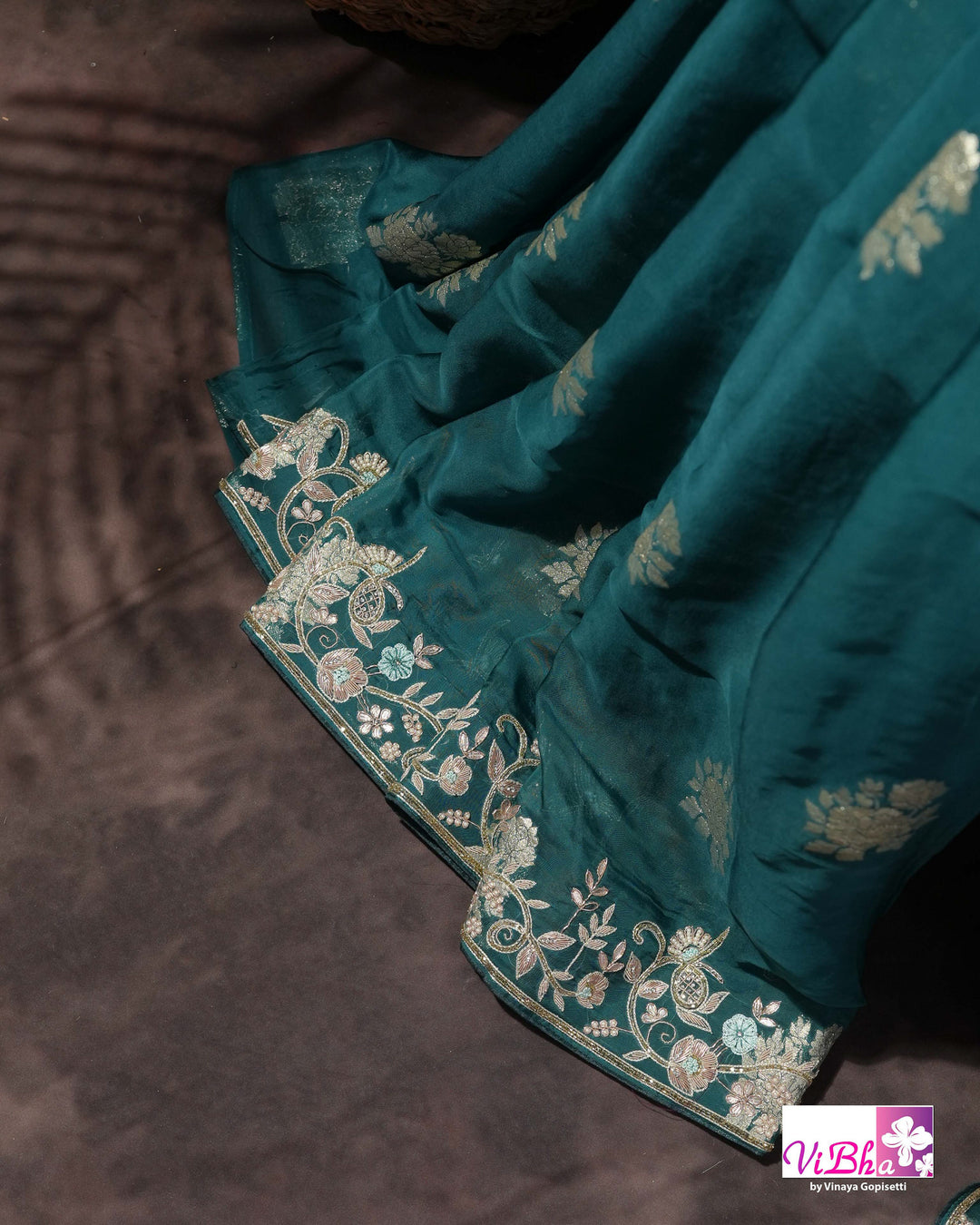 Teal Designer Saree with Floral Motifs and Embroidered Vine Border