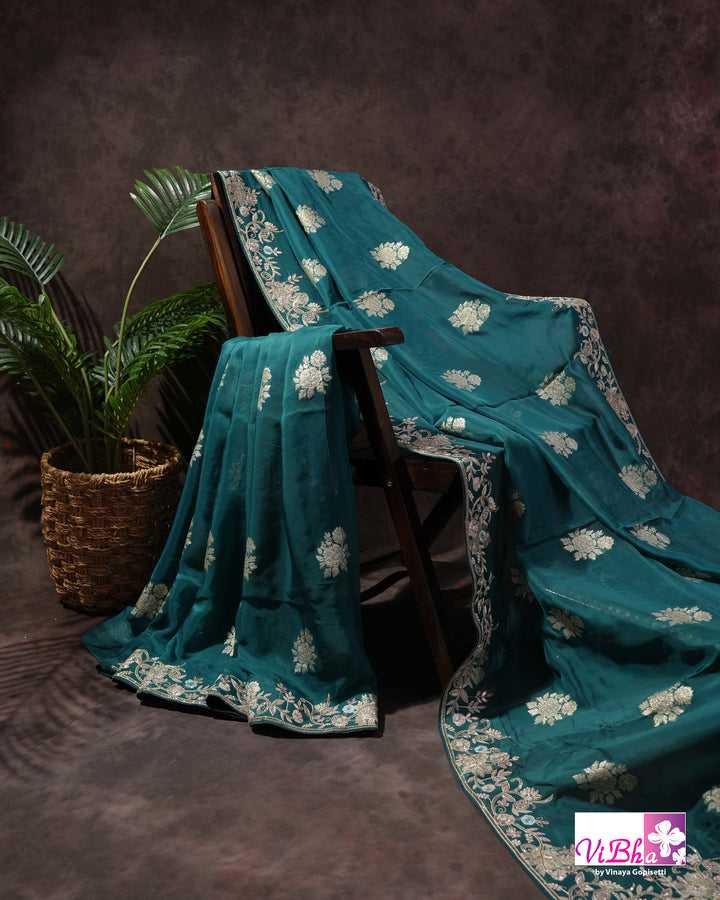 Teal Designer Saree with Floral Motifs and Embroidered Vine Border