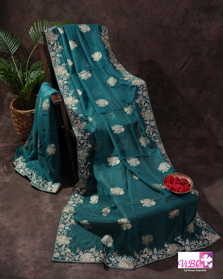 Teal Designer Saree with Floral Motifs and Embroidered Vine Border