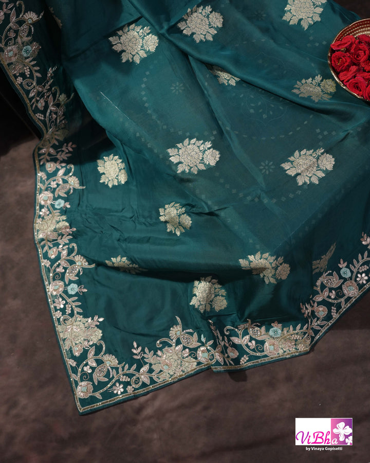 Teal Designer Saree with Floral Motifs and Embroidered Vine Border