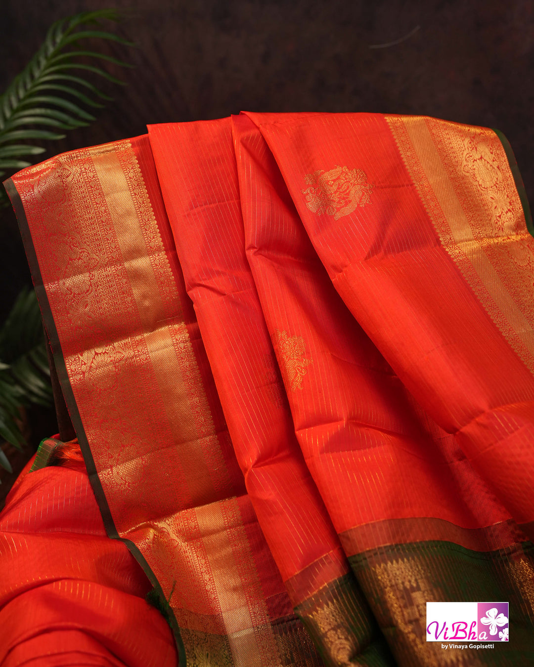 Vermilion Orange Kanchi Silk Saree with Gold Zari Weaving and Green Embroidered Blouse