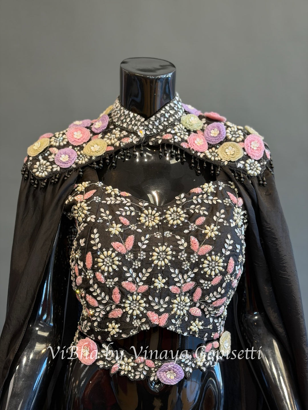 Black pre draped saree and blouse with a cape