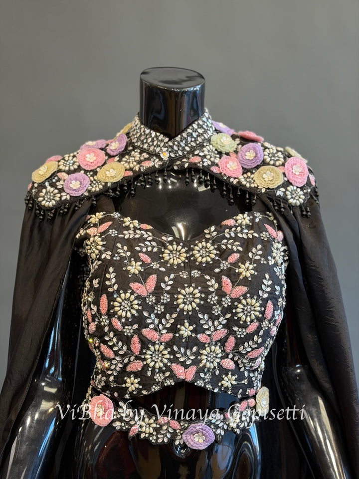 Black pre draped saree and blouse with a cape