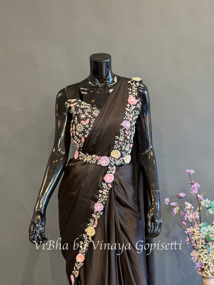Black pre draped saree and blouse with a cape