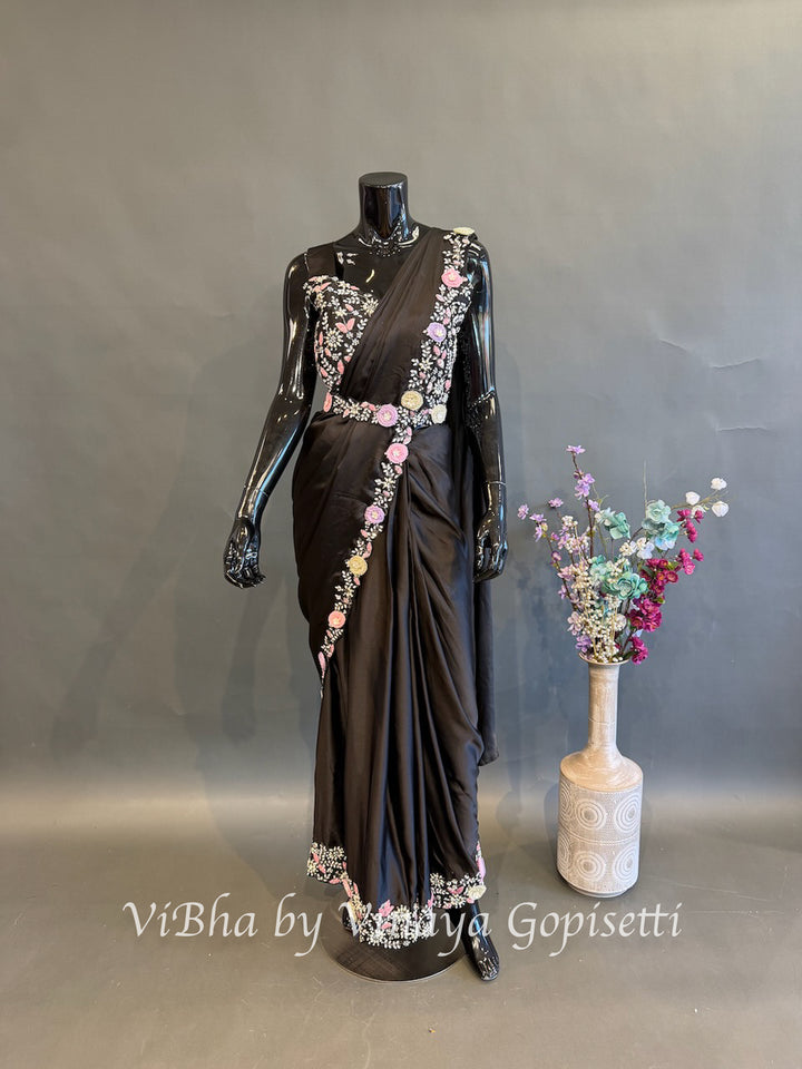 Black pre draped saree and blouse with a cape