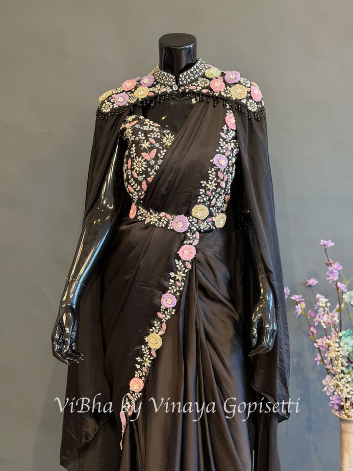 Black pre draped saree and blouse with a cape
